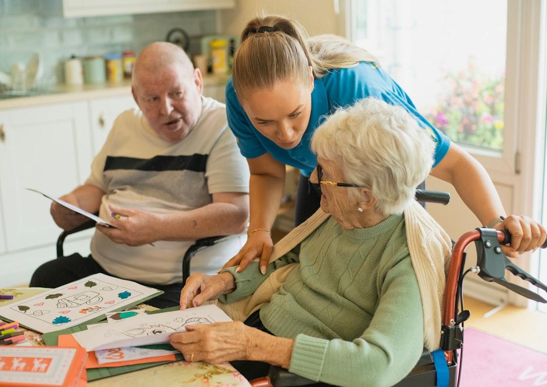 caregiver-assisting-elderly-couple-with-coloring-bsxk1lop8t0
