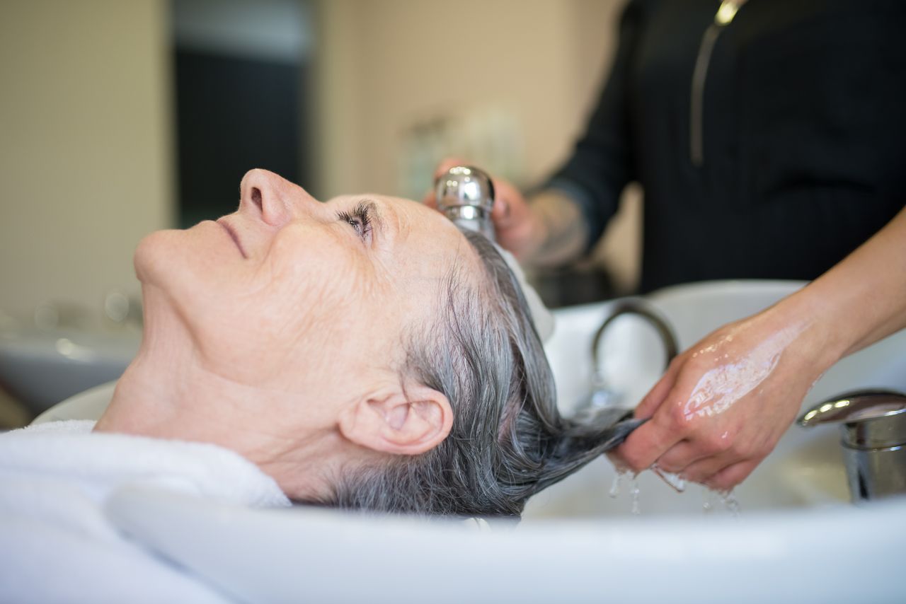 The Art of Drawing Readers In: Your attractive post title goes here Elderly woman enjoying a relaxing hair wash session in a professional salon setting.